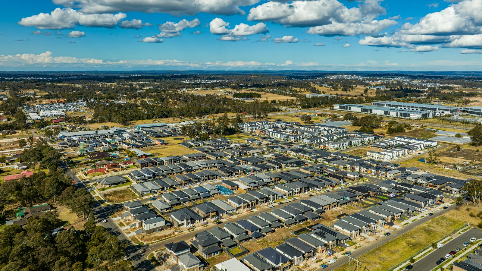 Aerial view of a new housing subdivision spreading into open land